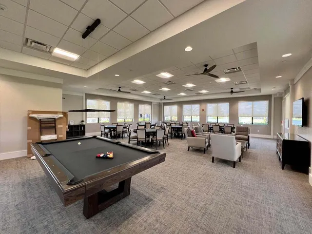 a view of a house with a big yard and large trees