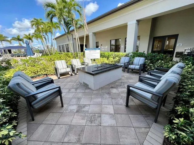 a view of a patio with a table and chairs under an umbrella