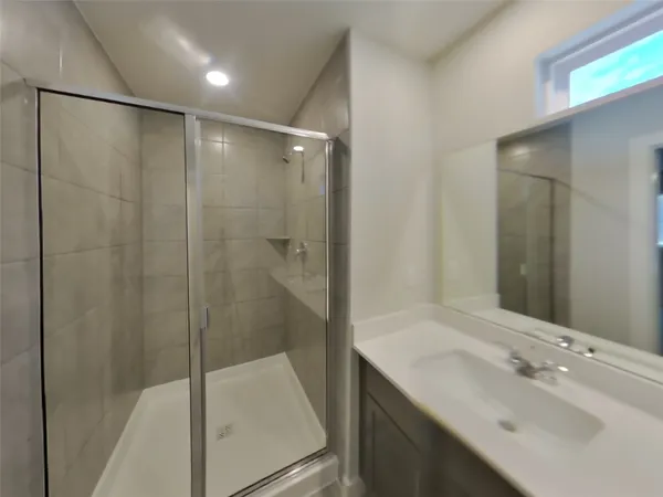 a bathroom with a shower and a sink