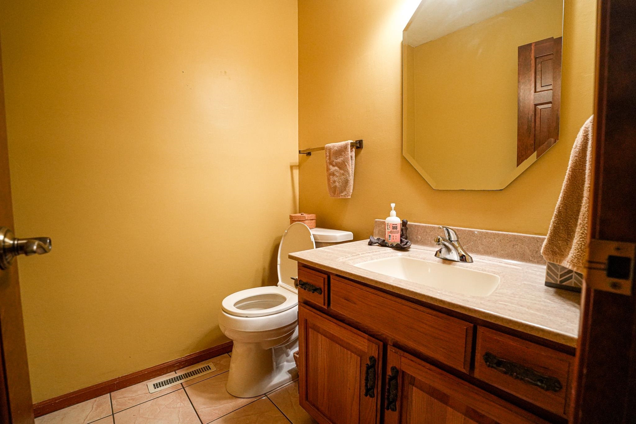 10340 William Trail Roscoe, IL 61073 - Photo 11 of 27 a bathroom with a sink mirror vanity and toilet