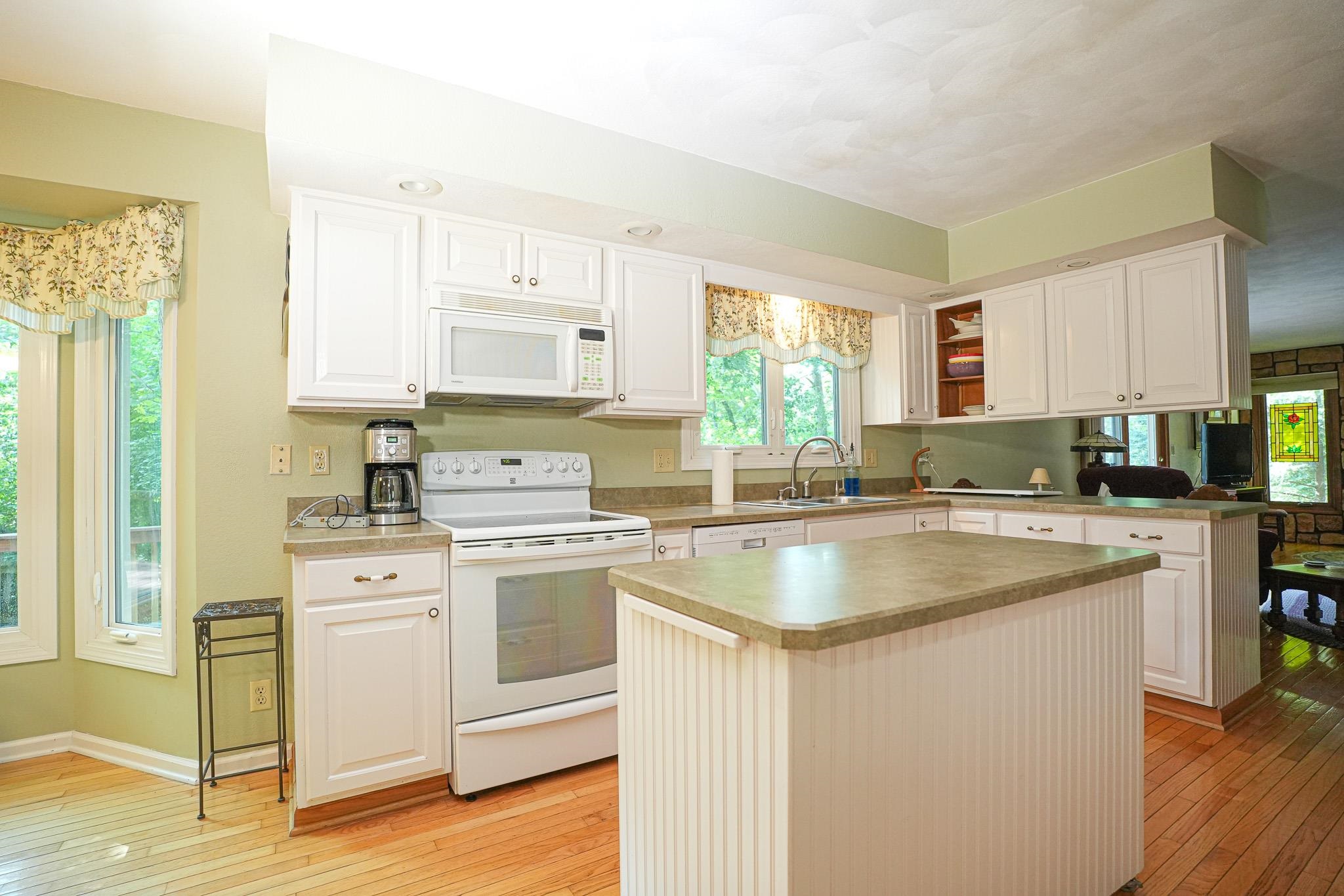 10340 William Trail Roscoe, IL 61073 - Photo 13 of 27 a kitchen with stainless steel appliances granite countertop a sink stove and refrigerator