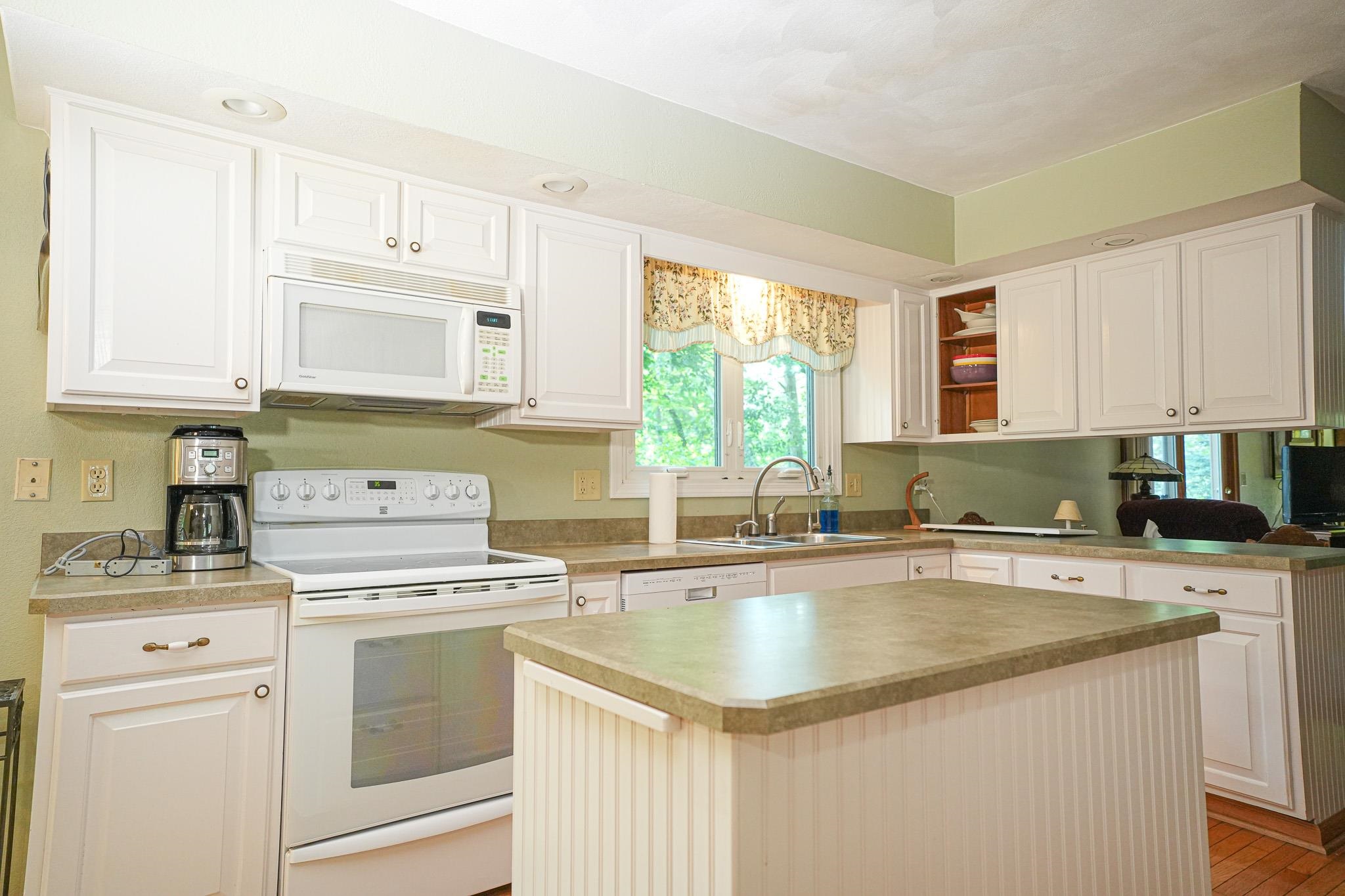 10340 William Trail Roscoe, IL 61073 - Photo 14 of 27 a kitchen with stainless steel appliances granite countertop a sink stove and cabinets