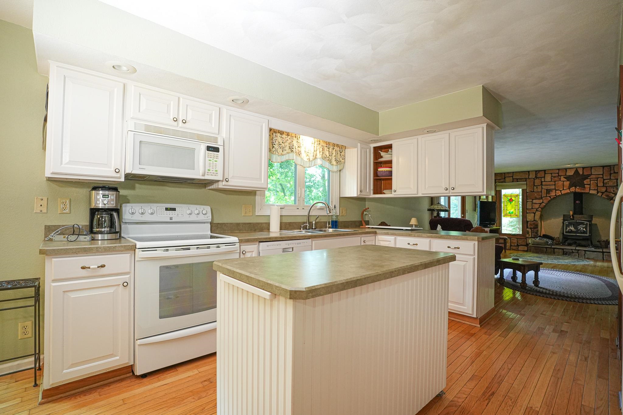 10340 William Trail Roscoe, IL 61073 - Photo 15 of 27 a kitchen with stainless steel appliances granite countertop a sink stove and refrigerator