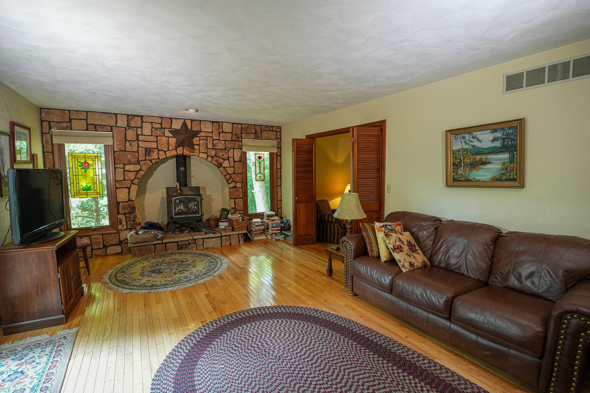10340 William Trail Roscoe, IL 61073 - Photo 16 of 27 a living room with furniture a flat screen tv and a large window