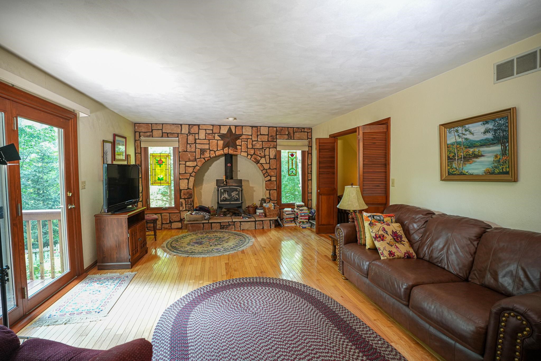 10340 William Trail Roscoe, IL 61073 - Photo 18 of 27 a living room with furniture fireplace and large windows