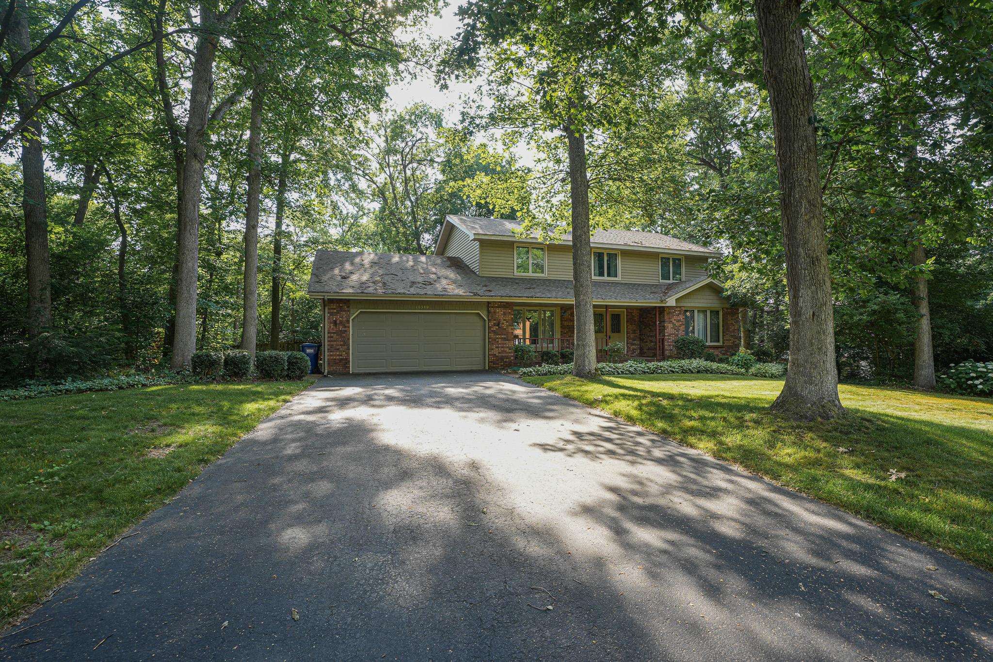 10340 William Trail Roscoe, IL 61073 - Photo 2 of 27 a view of a house with a yard and large tree