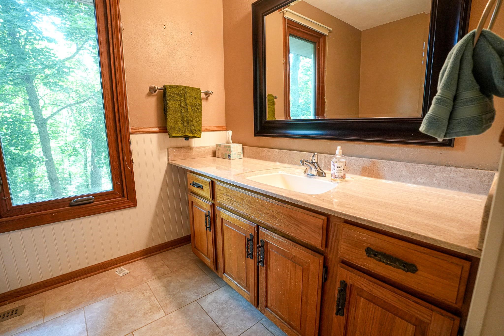 10340 William Trail Roscoe, IL 61073 - Photo 24 of 27 a bathroom with a double vanity sink and a mirror