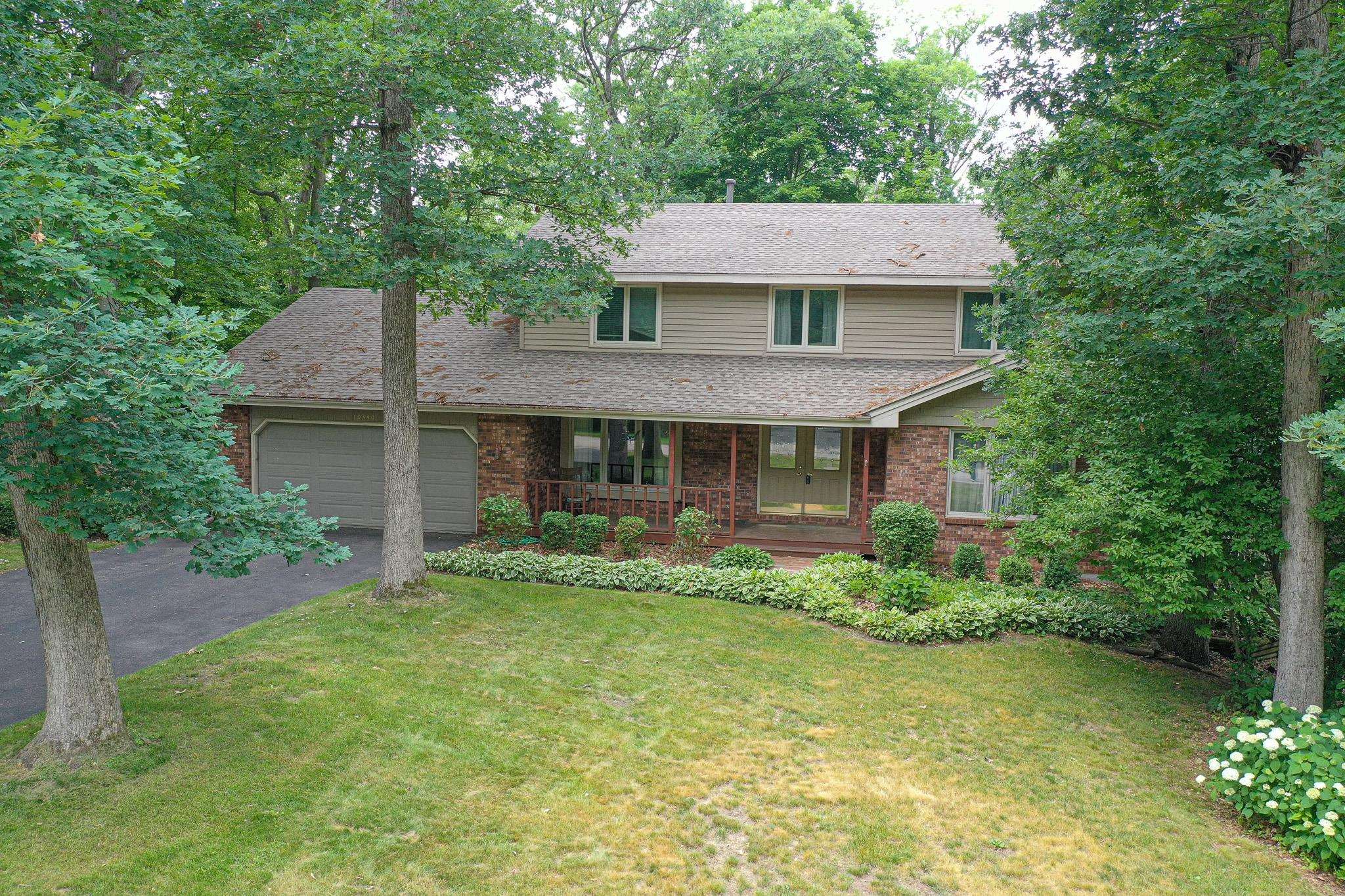 10340 William Trail Roscoe, IL 61073 - Photo 3 of 27 a front view of a house with a garden and plants