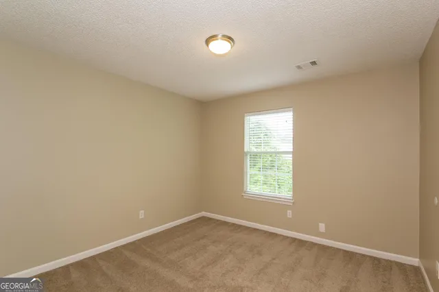 a view of a big room with windows