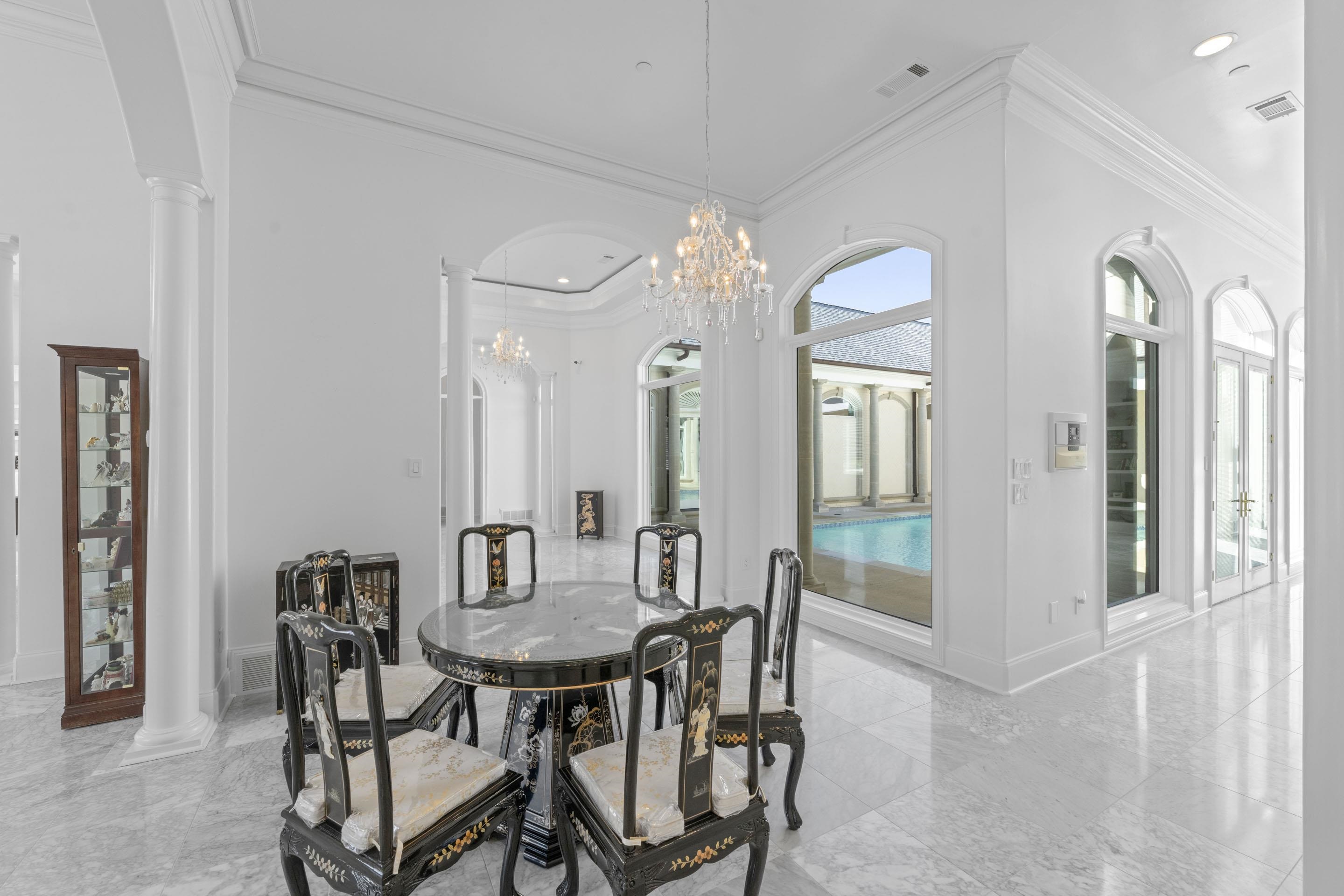 881 Bray Station Road Collierville, TN 38017 - Photo 4 of 40 Dining room featuring ornate columns, ornamental molding, light marble finish floors, a chandelier, and recessed lighting