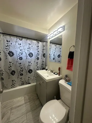 a bathroom with a toilet sink and mirror