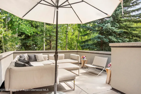 a view of balcony with couch and chairs