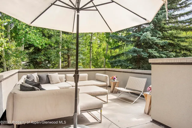 a view of balcony with couch and chairs
