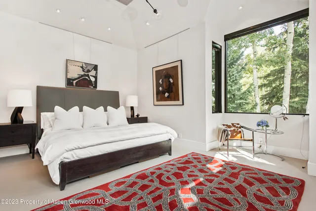 a bedroom with a large bed and a large window