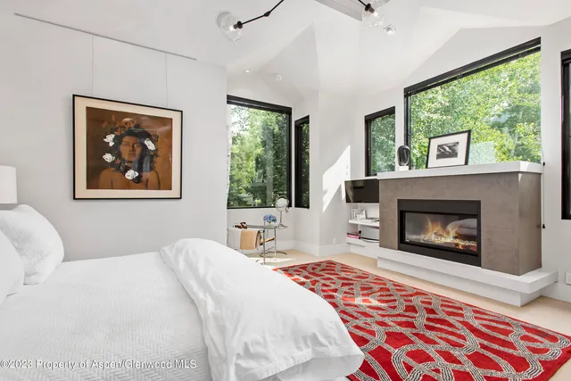 a bedroom with a bed and a fireplace