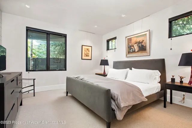 a spacious bedroom with a large bed and a window