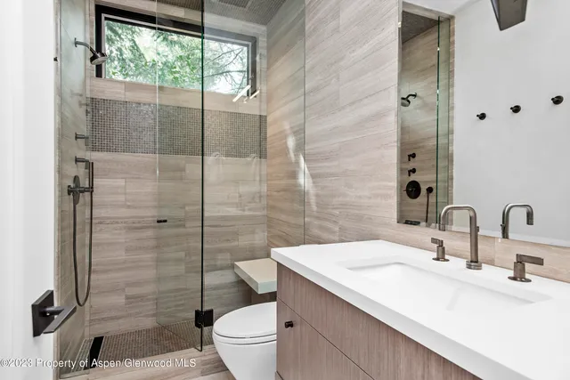 a bathroom with a sink toilet and shower