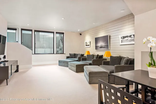 a living room with furniture wooden floor and a flat screen tv