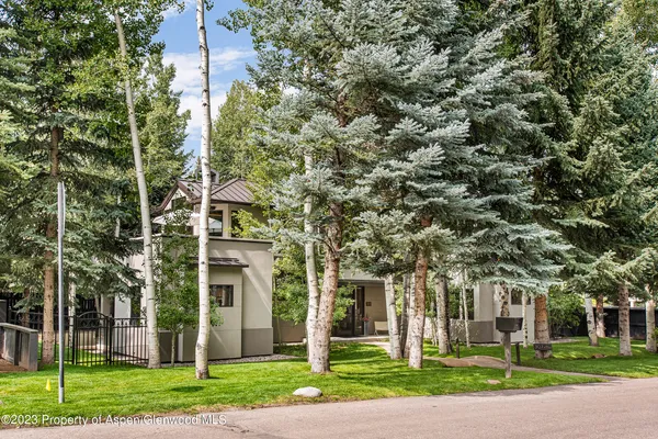 front view of a building with a tree