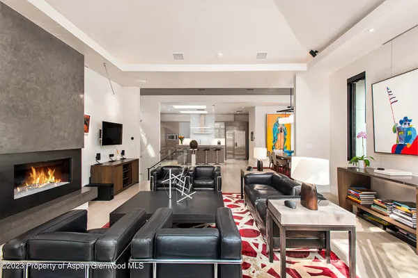 a living room with furniture fireplace and flat screen tv