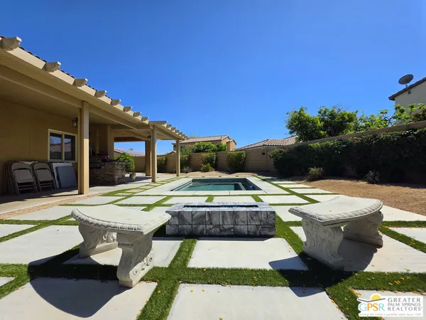 a view of a swimming pool with outdoor seating
