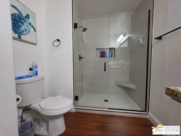 a bathroom with a toilet and a shower