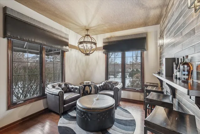 a room with wooden floor and windows