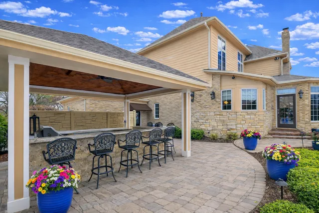 a view of a patio with couches table and chairs and potted plants