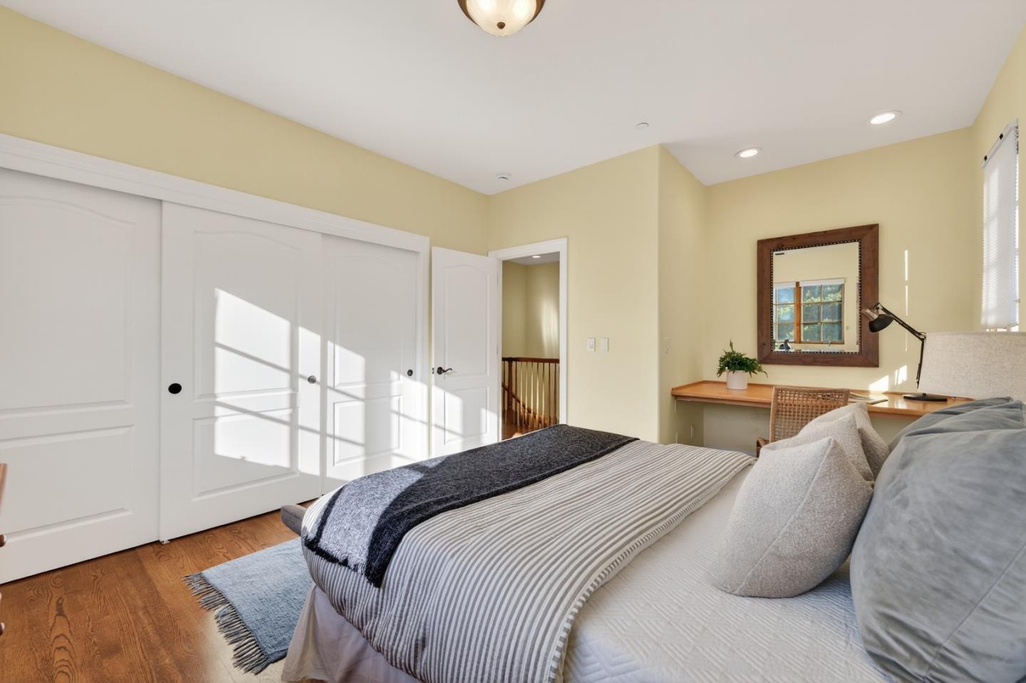 17599 Montebello Road Cupertino, CA 95014 - Photo 43 of 83 a bedroom with a bed and a large mirror