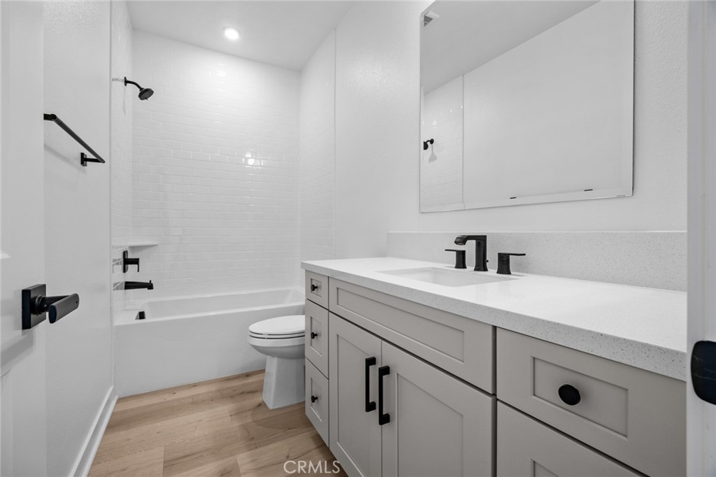 16642 Ginger Creek Drive Riverside, CA 92504 - Photo 11 of 22 a bathroom with a sink a toilet and shower