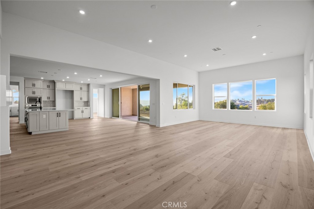 16642 Ginger Creek Drive Riverside, CA 92504 - Photo 13 of 22 an empty room with wooden floor and windows