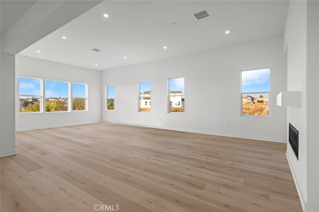 16642 Ginger Creek Drive Riverside, CA 92504 - Photo 16 of 22 a view of an empty room with a window and wooden floor