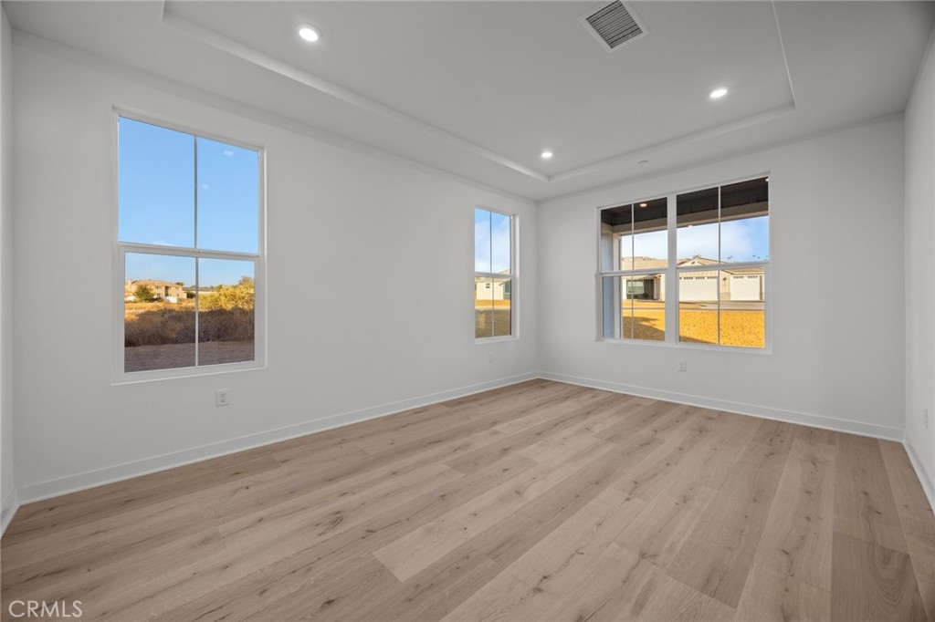 16642 Ginger Creek Drive Riverside, CA 92504 - Photo 22 of 22 an empty room with wooden floor and windows