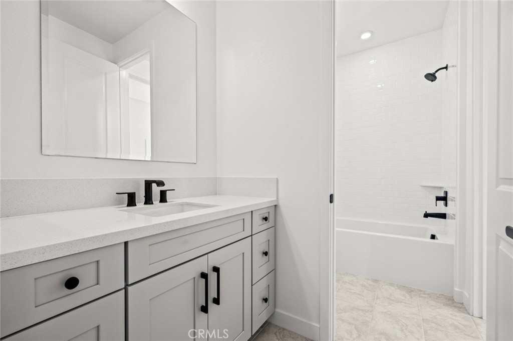 16642 Ginger Creek Drive Riverside, CA 92504 - Photo 7 of 22 a bathroom with a sink and a mirror