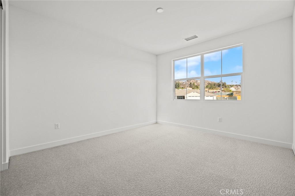 16642 Ginger Creek Drive Riverside, CA 92504 - Photo 9 of 22 an empty room with windows
