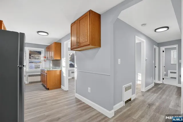 a kitchen with stainless steel appliances granite countertop a refrigerator and a stove