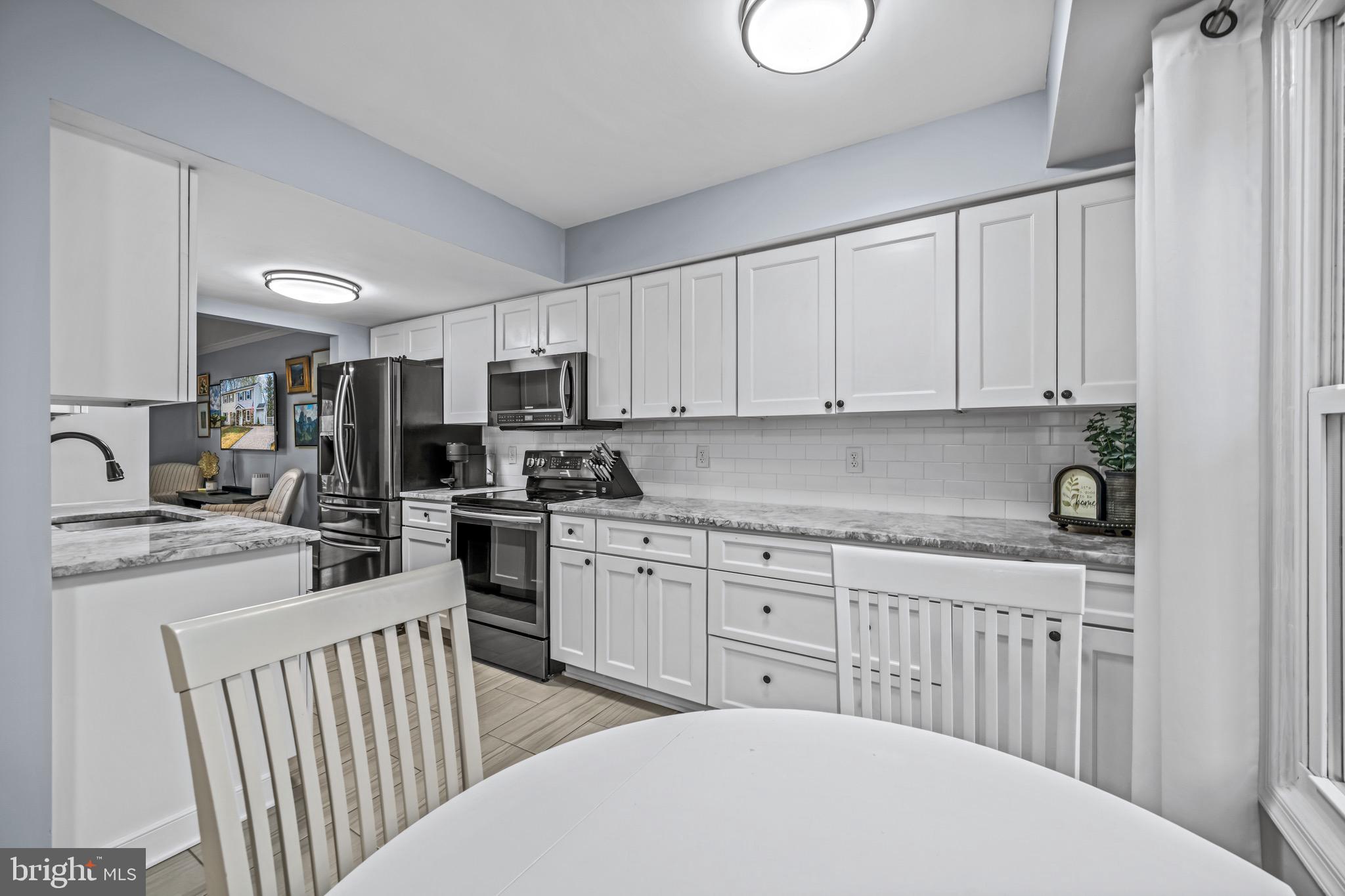 129 McKinsey Road Severna Park, MD 21146 - Photo 13 of 38 a kitchen with stainless steel appliances a stove a sink a microwave and cabinets