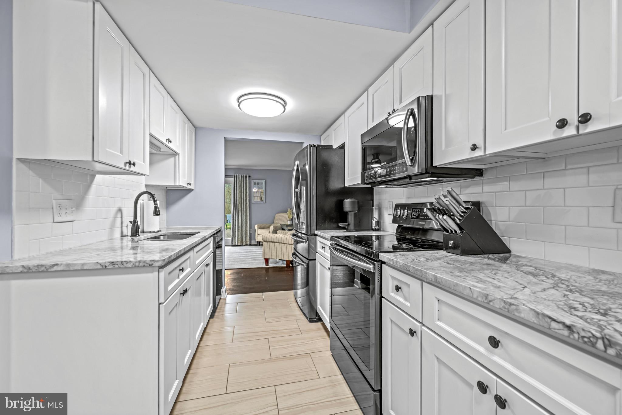 129 McKinsey Road Severna Park, MD 21146 - Photo 14 of 38 a kitchen with stainless steel appliances granite countertop a sink stove and cabinets
