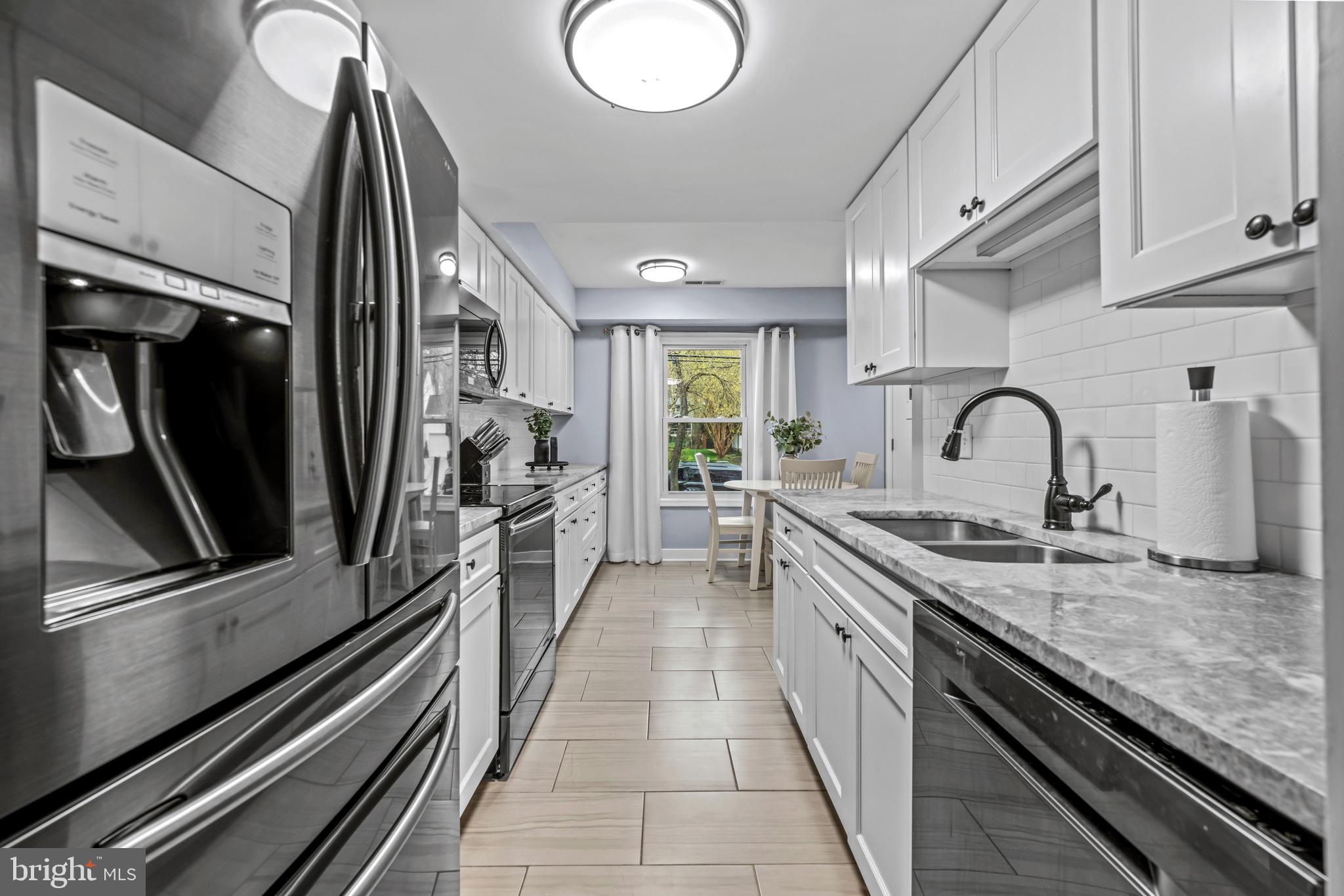 129 McKinsey Road Severna Park, MD 21146 - Photo 15 of 38 a kitchen with granite countertop a sink and stainless steel appliances