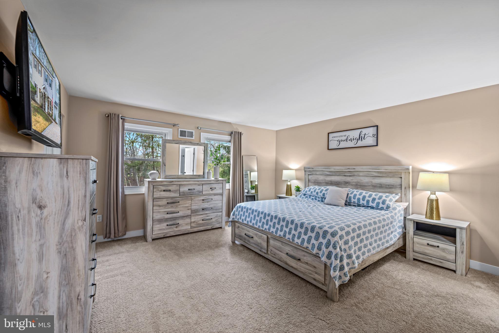 129 McKinsey Road Severna Park, MD 21146 - Photo 23 of 38 a bedroom with a bed and a flat tv screen