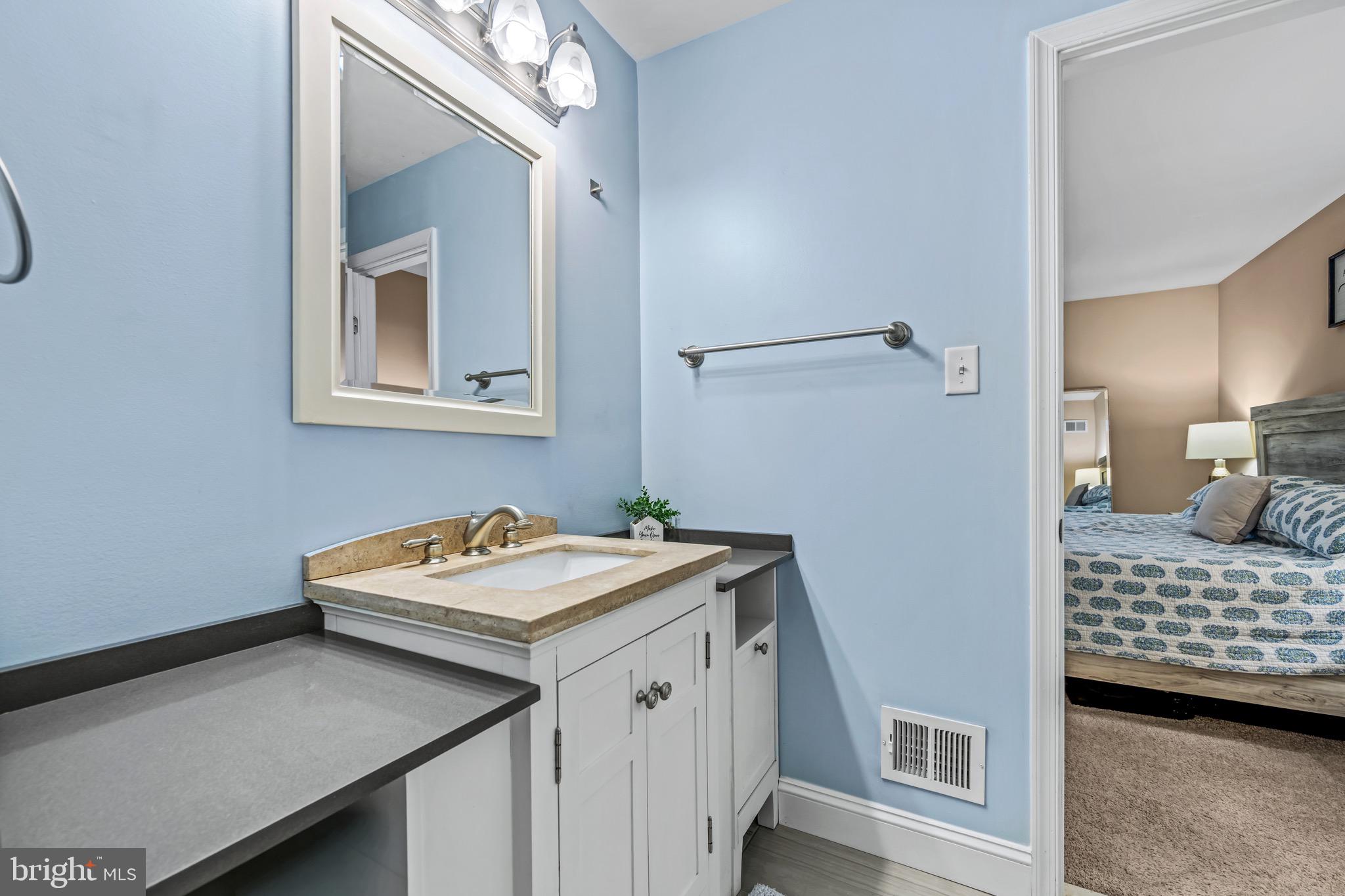 129 McKinsey Road Severna Park, MD 21146 - Photo 26 of 38 a bathroom with a sink a light fixture and a toilet