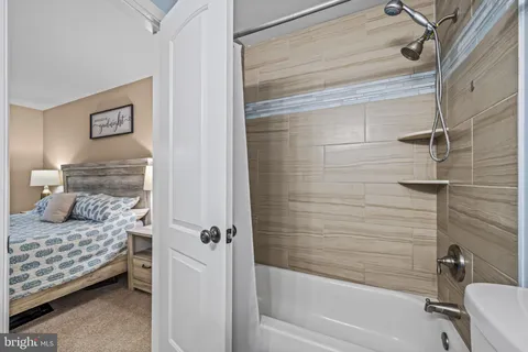 a bathroom with a bathtub and shower