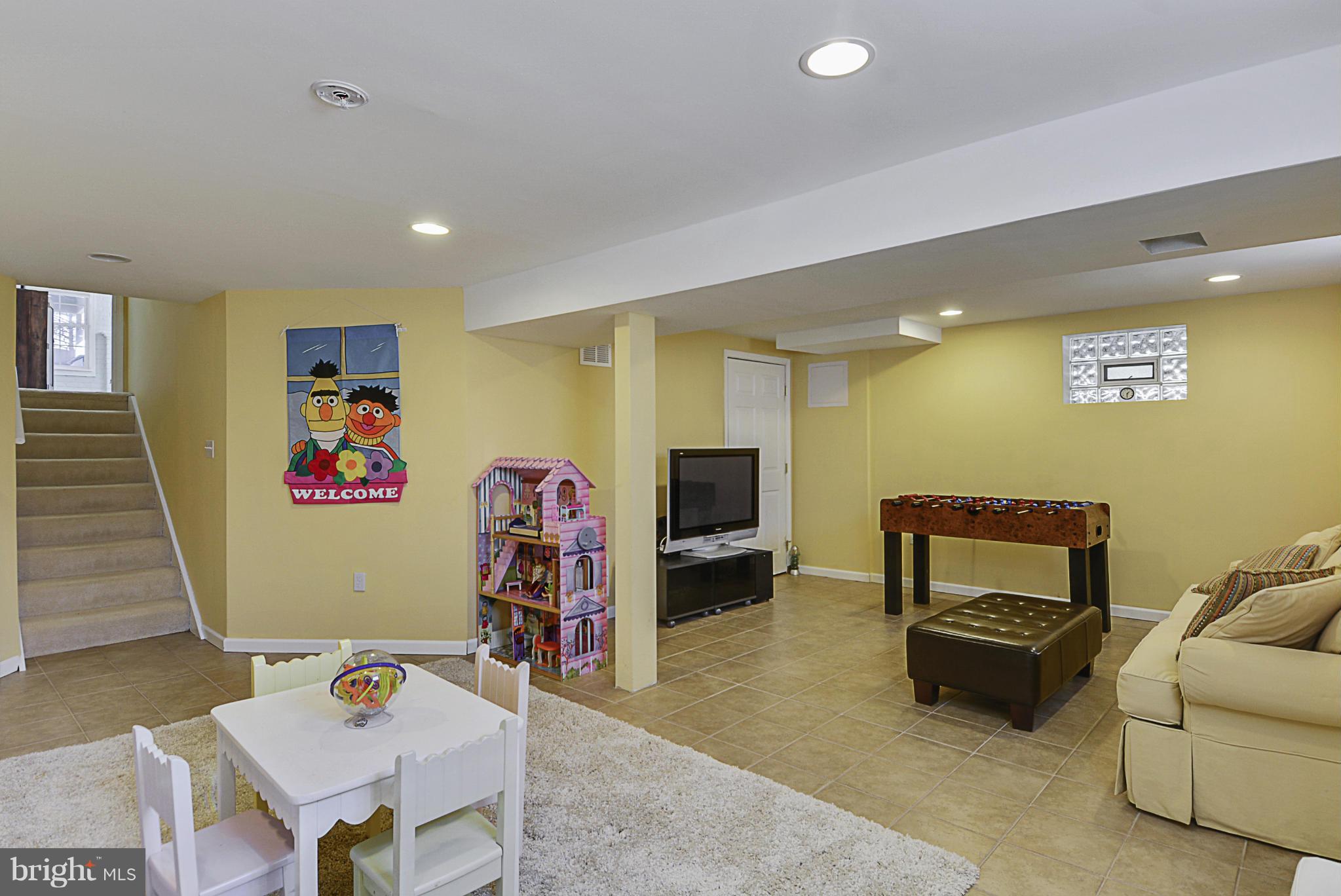 1597 Kimblewick Road Potomac, MD 20854 - Photo 22 of 30 a living room with furniture and a flat screen tv