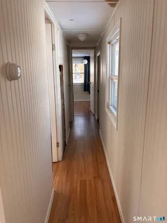 a view of gallery with wooden floor