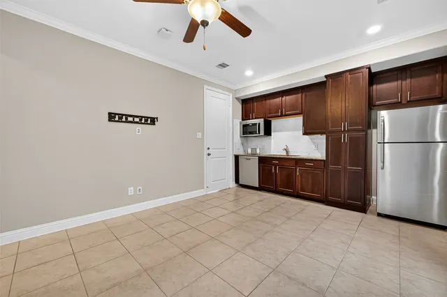 a view of kitchen with granite countertop cabinets and stainless steel appliances