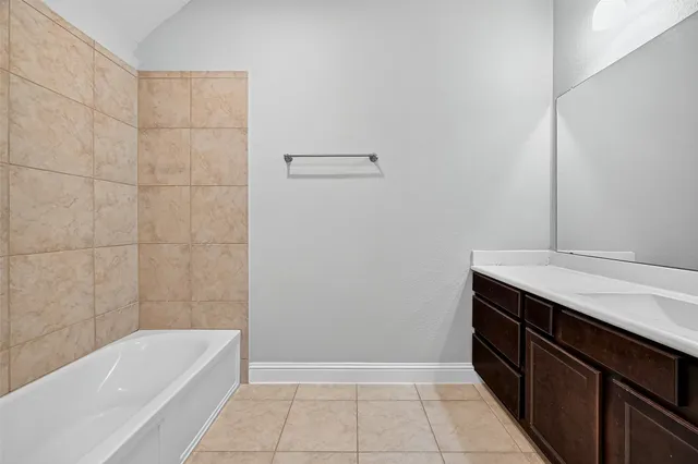 an empty room with chandelier fan