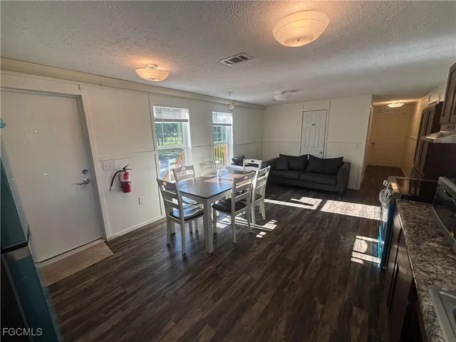 a view of a field with a tree in the background