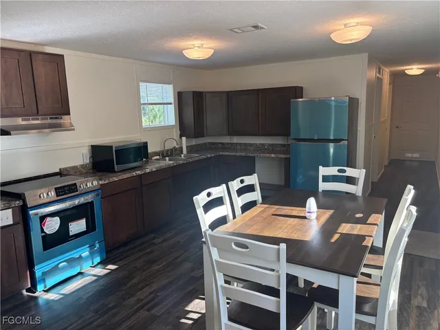 a white toilet sitting next to a small sink
