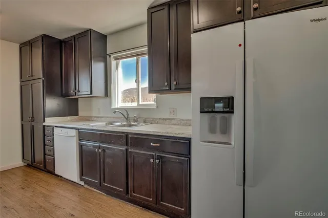 a kitchen with a sink and a refrigerator
