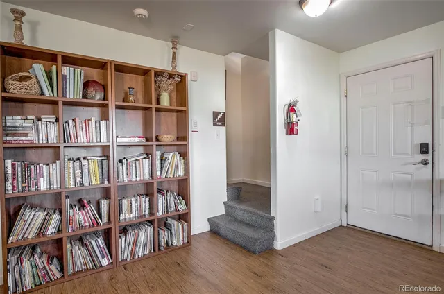 a view of room with furniture book shelf and shelf